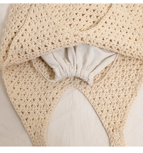 Detail of hand-crocheted hollow cotton tote bag with interior drawstring pouch for security