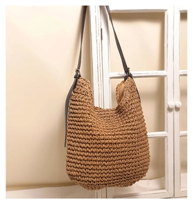 Detail of hand-woven straw tote with premium brown PU leather adjustable shoulder strap