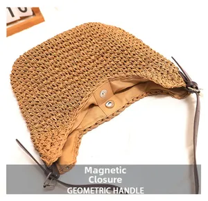 Detail view of woven straw shoulder bag with magnetic closure and PU leather strap