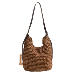 Caramel brown large capacity straw bucket bag with adjustable leather shoulder strap