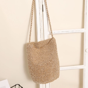 Stylish hand-woven straw shoulder bag in light brown for summer beach vacations