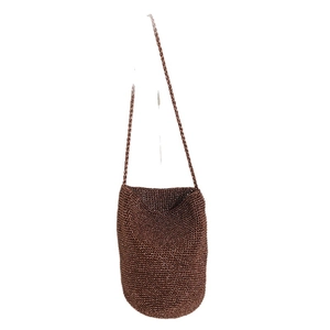 Handmade brown straw bucket bag with woven shoulder strap for beach vacation styling