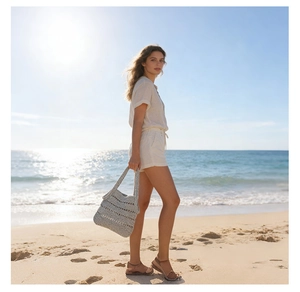 Detail of white hollow-out crochet straw tote bag showing intricate handmade texture
