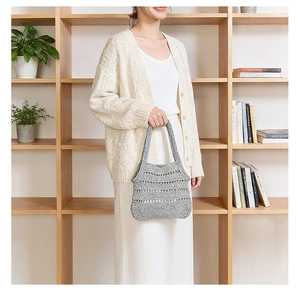 Detailed close-up of a grey hollow crochet woven beach bag with premium mesh texture