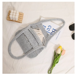 Detail of silver crochet tote bag with mesh hollow structure and drawstring inner bag