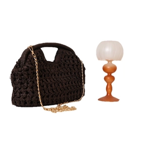 Stylish dark brown woven straw crossbody bag with golden chain strap for beach vacation