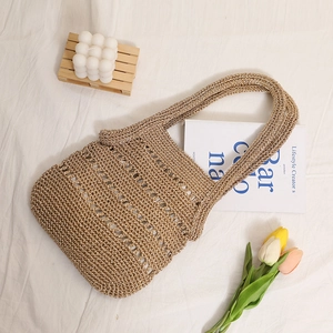 Handmade woven gold straw tote bag with cut-out pattern for beach vacation