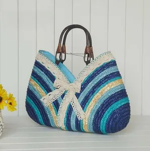 Macro detail of multi-colored straw beach bag with lace trim and brown handles