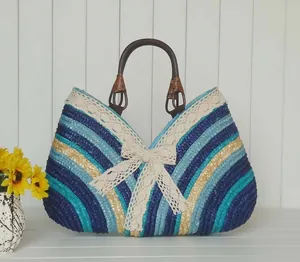 Detail of colorful woven straw bag featuring lace trim and circular wooden handles