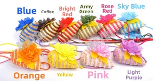 Detailed close-up showing a variety of colorful mini straw bags with decorative fabric flowers