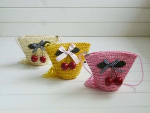 Three colorful handmade straw crossbody bags with cute cherry pendants and bows for girls
