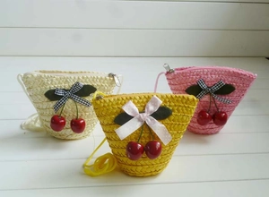 Detailed set of three straw crossbody bags in cream, yellow and pink with cherry charms