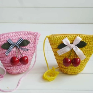 Cute cherry straw woven crossbody bags in pink and yellow for summer beach vacations