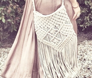 Close-up of bohemian cream cotton woven crossbody bag featuring long fringe tassels
