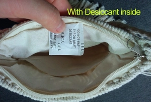 Detail view of woven bag interior featuring zipper closure, lining, and desiccant packet