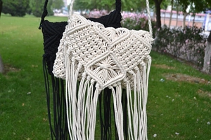 Detailed close-up of macrame woven patterns and tassel fringes on bohemian beach bags