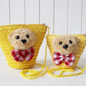 Handwoven straw shoulder bags in two sizes featuring cute plush bear with bow tie decor