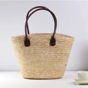 Embroidered straw tote bag with leather handles for casual summer beach vacations