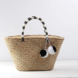 Large bohemian straw tote bag with black-white pom-poms and striped handles