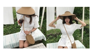 Close-up of handmade crochet straw crossbody bag and sun hat for summer beach vacation