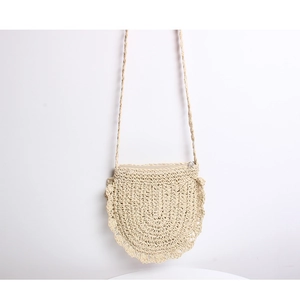 Close-up of cream handmade straw crossbody bag showing wavy ruffle edges and woven texture