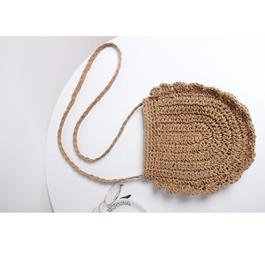 Minimalist straw crossbody beach bag with scallop edges and braided shoulder strap