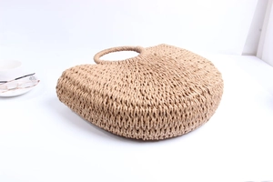 Detail of light khaki woven paper rope bucket bag with round integrated handles