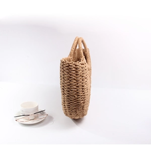 Minimalist straw bucket bag with woven rope texture and double handles for summer leisure
