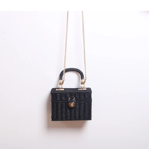 Elegante borsa a tracolla in paglia nera intrecciata con catena dorata e manico superiore