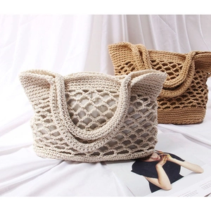 Detail of handmade crochet hollow mesh bags with inner liners in cream and brown