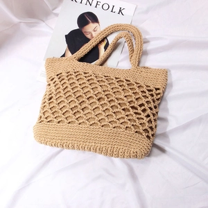 Handmade crochet beige straw tote bag with hollow mesh design for beach and summer style