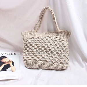 Detail of hand-woven beige tote bag with hollow diamond mesh pattern and inner lining