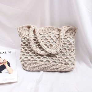 Detail of handmade cream crochet tote bag with hollow diamond mesh and interior lining