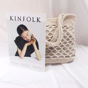 Detail of hollow out crochet pattern and cotton lining on beige handmade beach bag
