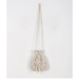 Detail of woven straw bag showing crochet texture, wooden beads, and tassel drawstring