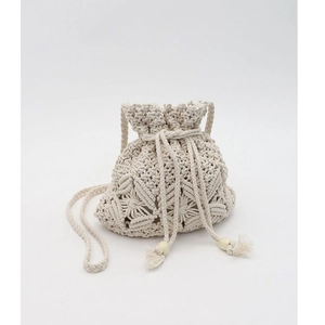 Close-up of handmade woven macrame bucket bag with drawstring and wooden beads