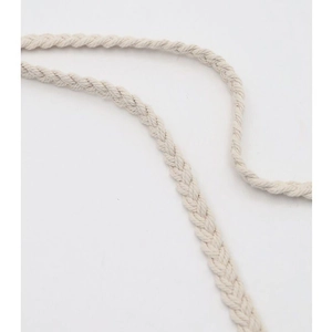 Detailed macro view of beige handmade cotton woven strap with natural fiber texture