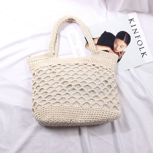 Handmade beige woven straw tote bag with cutout mesh design and inner lining for beach