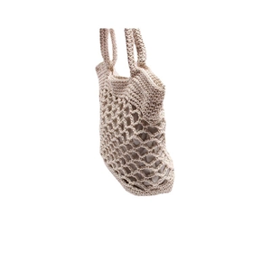 Handmade beige crochet tote bag with hollow diamond pattern and inner lining on white background