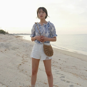 Chic handmade straw crossbody bag with tassels, ideal for summer beach vacations and travel