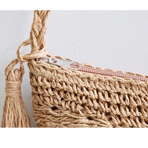 Handmade straw woven crossbody bag with fringe tassel and silver metal zipper closure