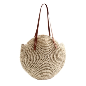 Large circular straw shoulder bag with brown leather straps for beach holidays