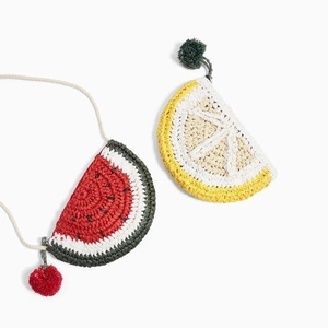 Detail of handmade crochet fruit bags showing watermelon and lemon slice patterns