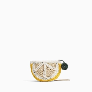 Handmade crochet lemon slice crossbody bag with green pompom detail and white strap