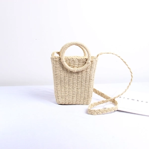 Handmade woven straw crossbody bag with circular handles for summer beach vacation