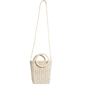 Minimalist beige woven straw beach bag with round handles and crossbody strap on white background