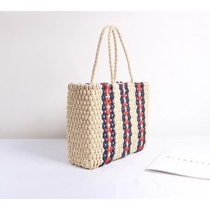 Striped straw tote bag for women featuring red and blue stripes and long handles