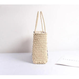 Large striped straw tote bag for beach vacations with natural woven texture and handles