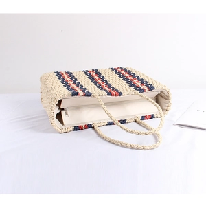 Straw tote bag with red and navy stripes, zipper closure and woven handles for beach