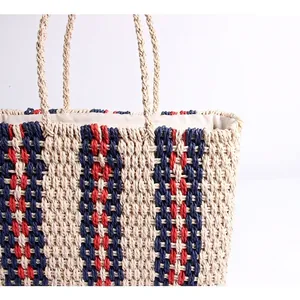 Striped straw tote bag with navy and red woven patterns for beach vacation and travel